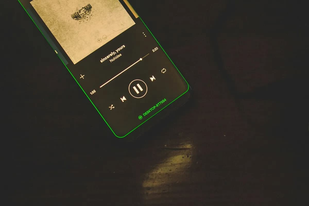 Android smartphone showing media player controls and track waveform